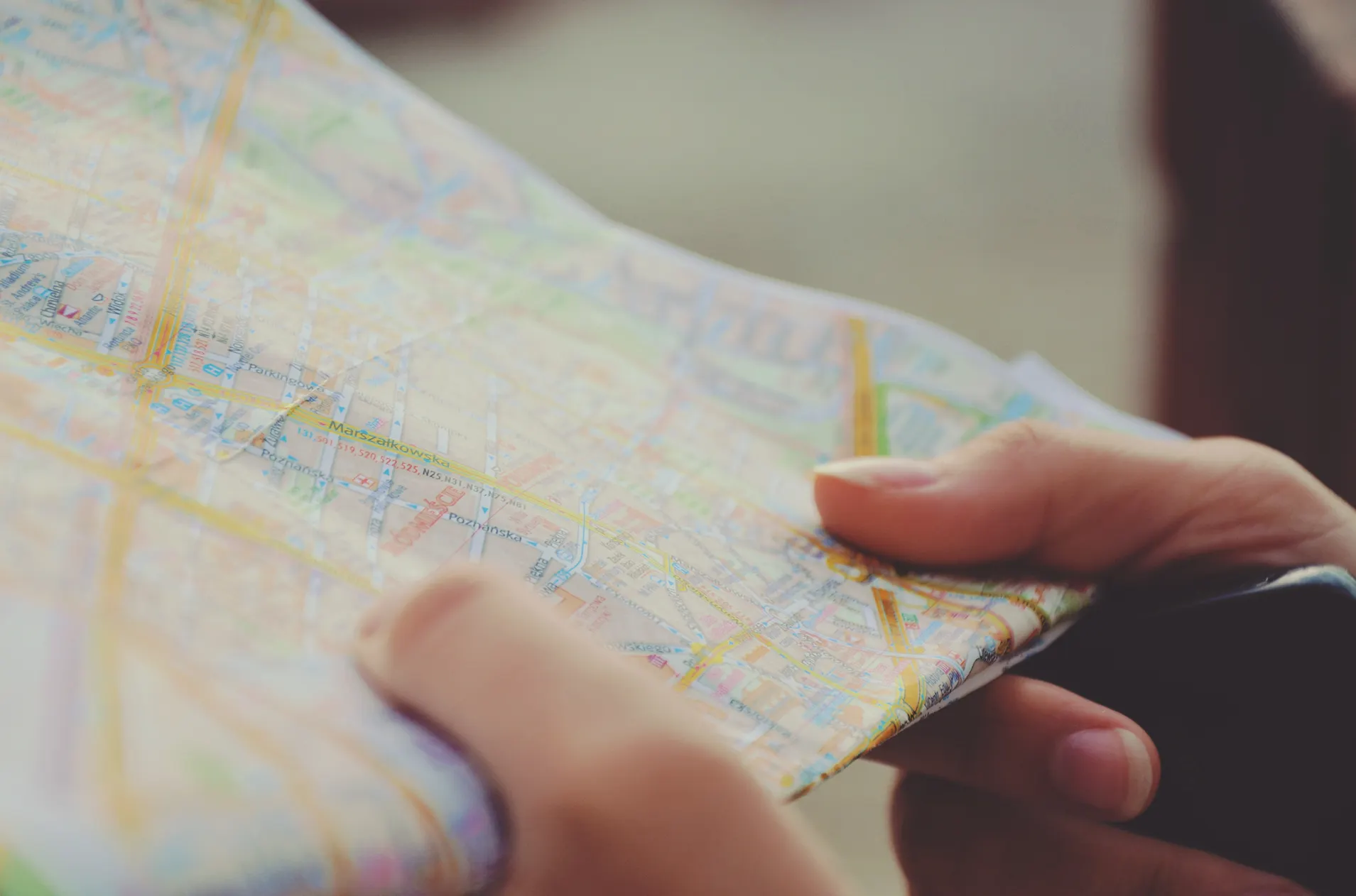 Two hands holding a paper map